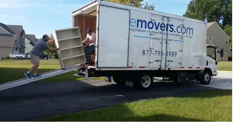 LiteMovers crew carrying a bookcase up the truck ramp