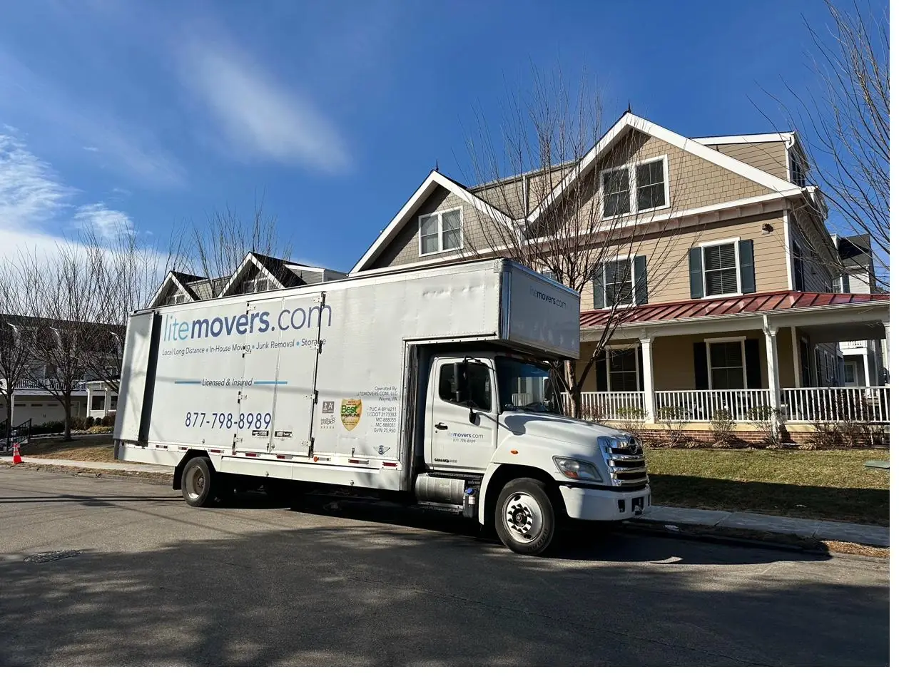 LiteMovers moving truck in front of a home with a wide front porch